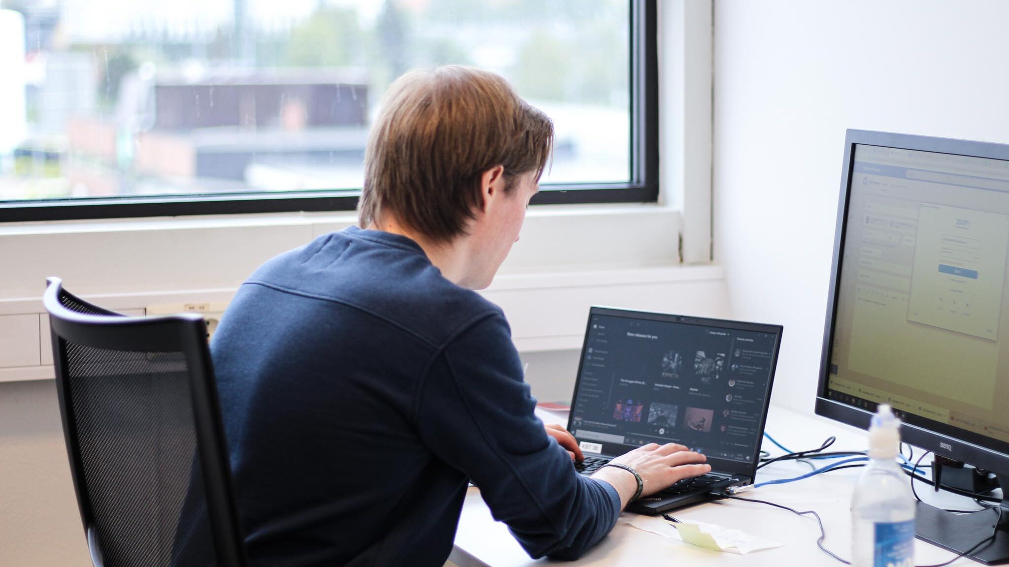 Picture of man typing on a computer