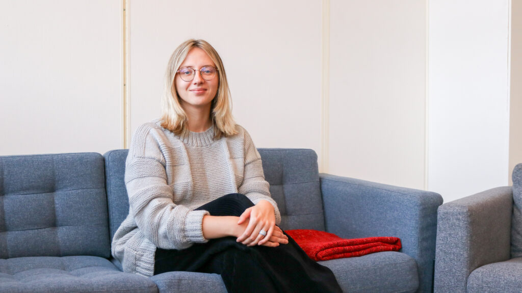 Photo of a young woman sitting in a sofa